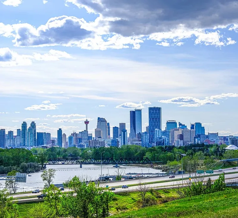 Calgary skyline beneath a bright blue sky.