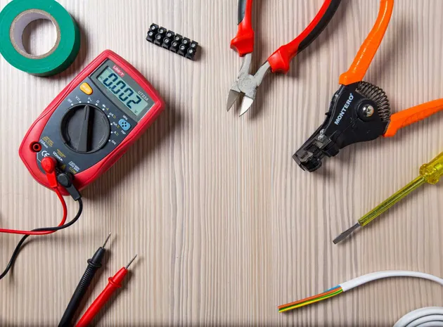 Electrician troubleshooting an electrical panel